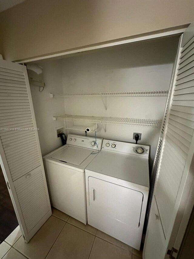 4848 N State Road 7 Unit 4305, Coconut Creek, FL 33073 - laundry area with washer and dryer and light tile patterned flooring