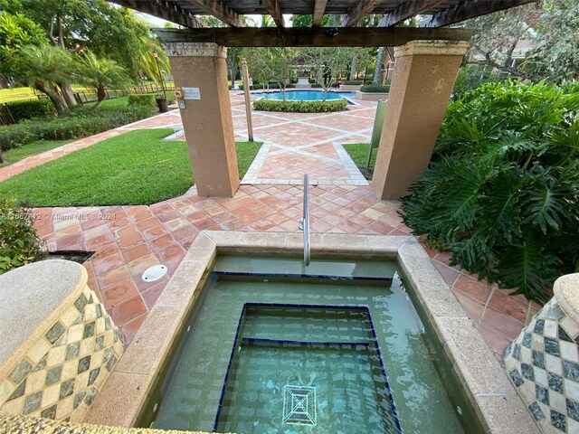 4848 N State Road 7 Unit 4305, Coconut Creek, FL 33073 - view of patio featuring a pergola and a community pool