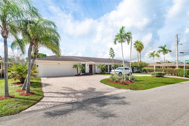 ranch-style home with a front yard and a garage