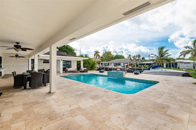 view of swimming pool with ceiling fan and a patio area