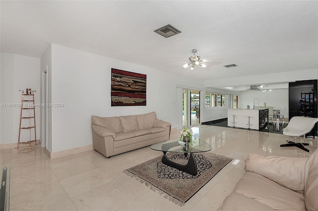 living room featuring sink and ceiling fan