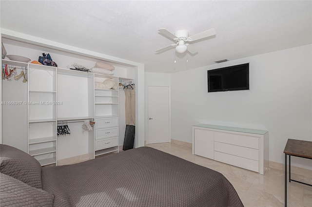 bedroom with ceiling fan and a closet