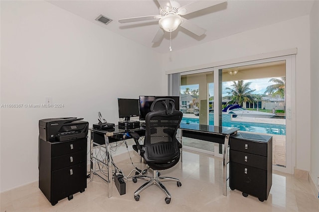 office featuring light tile patterned floors and ceiling fan