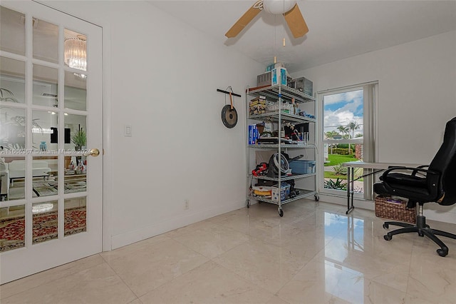 office space with ceiling fan with notable chandelier