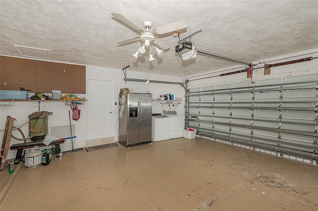 garage with ceiling fan, stainless steel refrigerator with ice dispenser, a garage door opener, and washing machine and clothes dryer