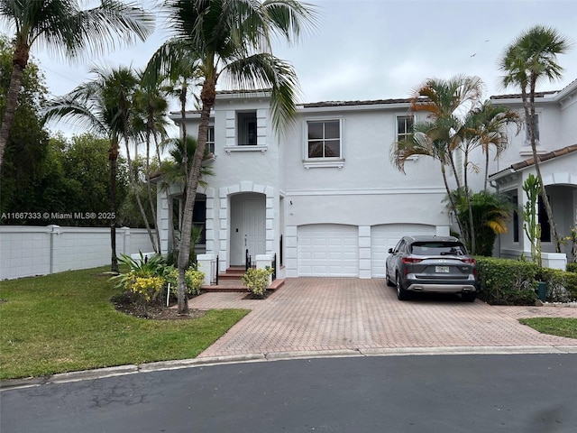 view of front of property with a front yard and a garage