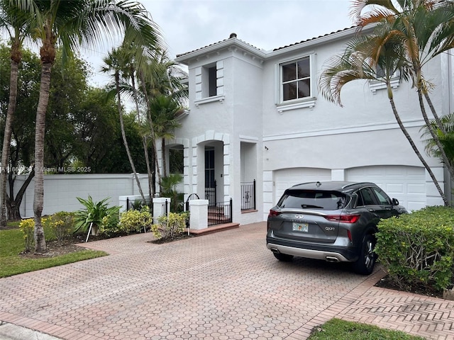 mediterranean / spanish house with a garage