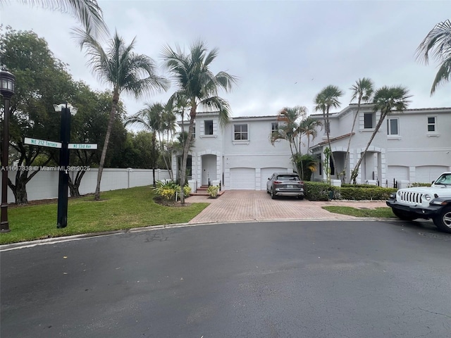 view of front of house with a front yard and a garage