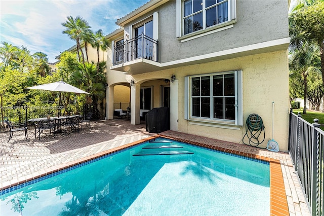 view of pool with ceiling fan and a patio