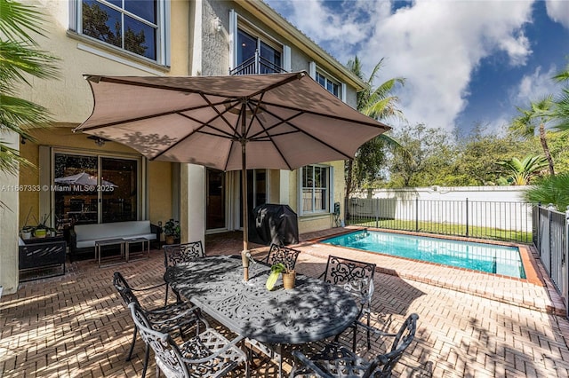 view of pool with a patio area and a grill