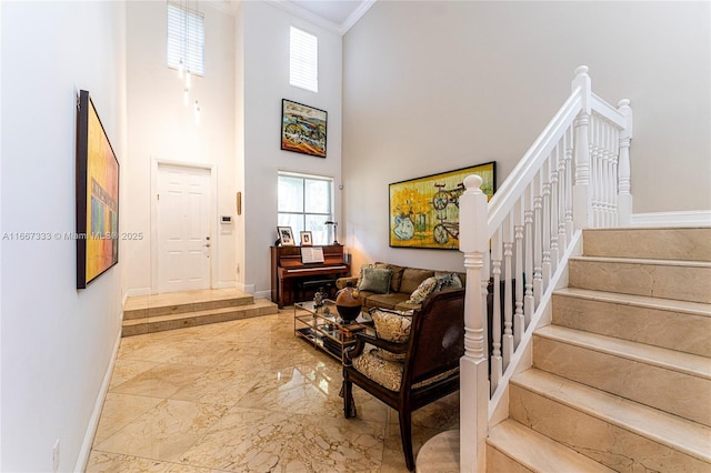 living room featuring a high ceiling and crown molding