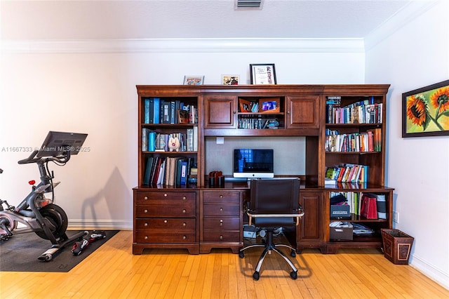 office area with crown molding and light hardwood / wood-style flooring