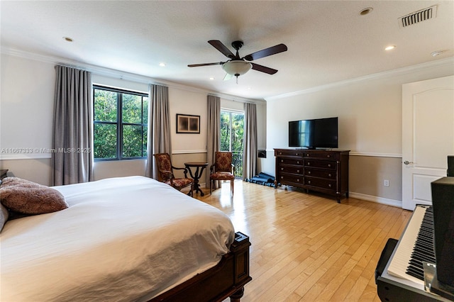 bedroom with light hardwood / wood-style floors, ceiling fan, and crown molding