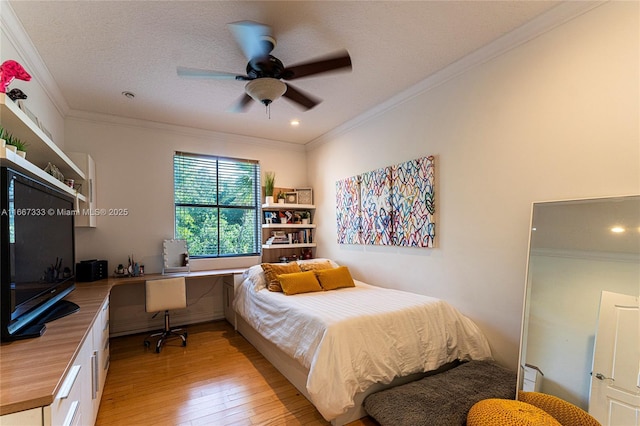 bedroom with ceiling fan, ornamental molding, a textured ceiling, and light wood-type flooring