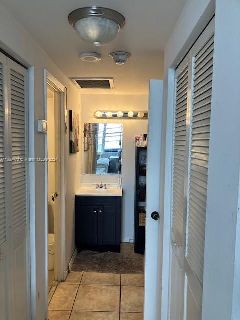 bathroom with vanity and tile patterned floors