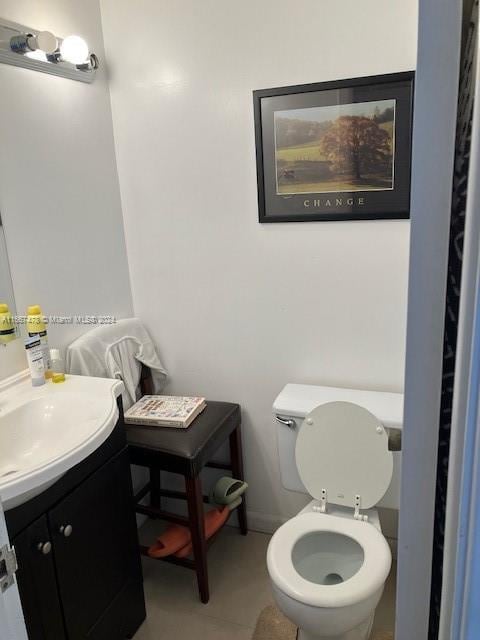 bathroom with tile patterned floors, vanity, and toilet