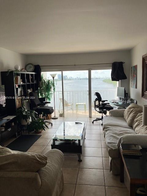 living room with light tile patterned floors and a wealth of natural light