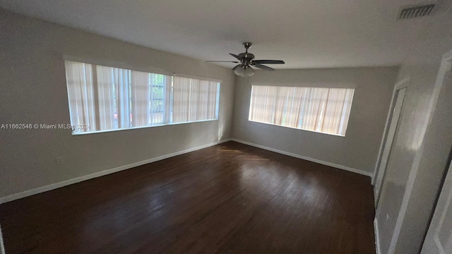 empty room featuring ceiling fan and dark wood-type flooring