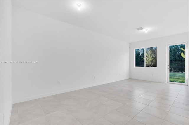 unfurnished room with light tile patterned floors