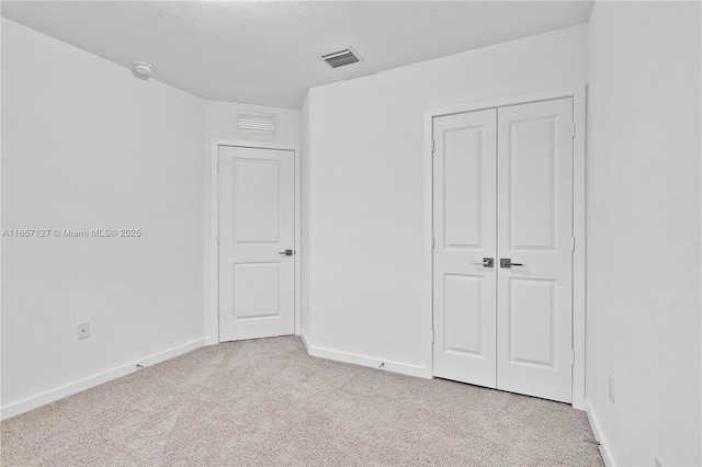 spare room featuring light colored carpet