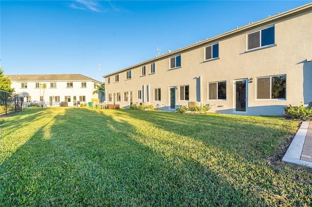 back of property featuring a lawn