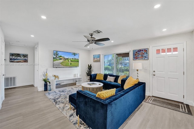 living room with ceiling fan and light hardwood / wood-style floors