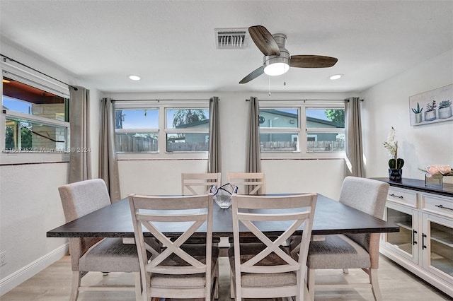 dining area with light hardwood / wood-style flooring and ceiling fan