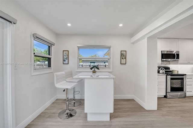 office area with light hardwood / wood-style floors