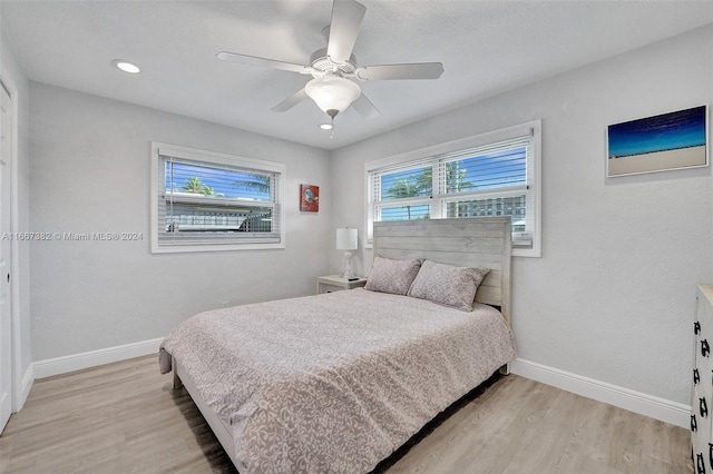 bedroom featuring ceiling fan and light hardwood / wood-style flooring