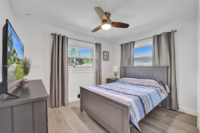 bedroom with ceiling fan and light hardwood / wood-style floors