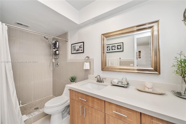 bathroom featuring vanity, toilet, and curtained shower