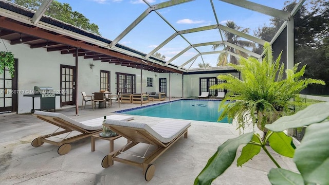 pool featuring a patio, french doors, and glass enclosure