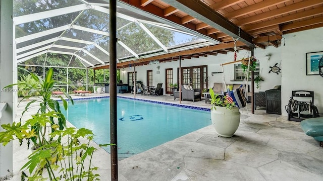 pool featuring a patio area and glass enclosure
