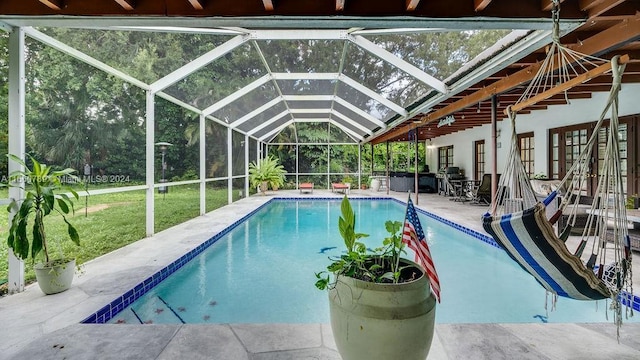 pool featuring a lanai, a patio, and a yard