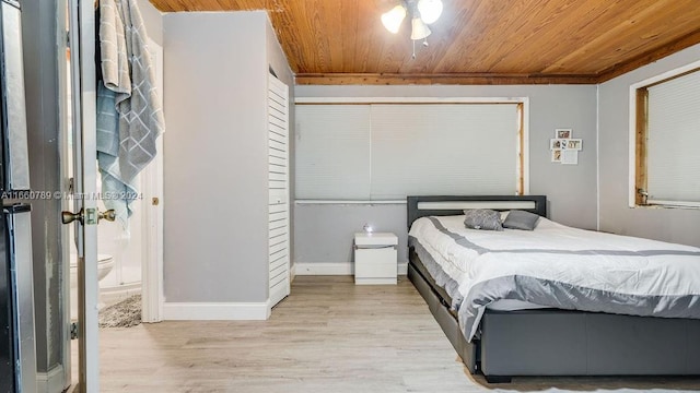 bedroom featuring wood ceiling, baseboards, and wood finished floors