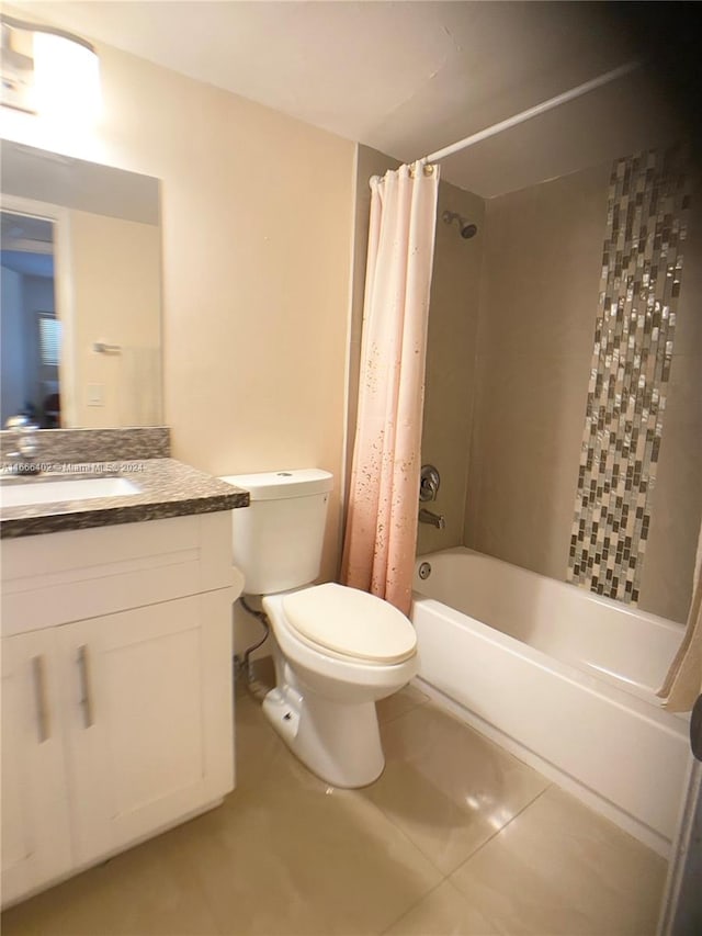 full bathroom with shower / bath combo with shower curtain, tile patterned flooring, vanity, and toilet