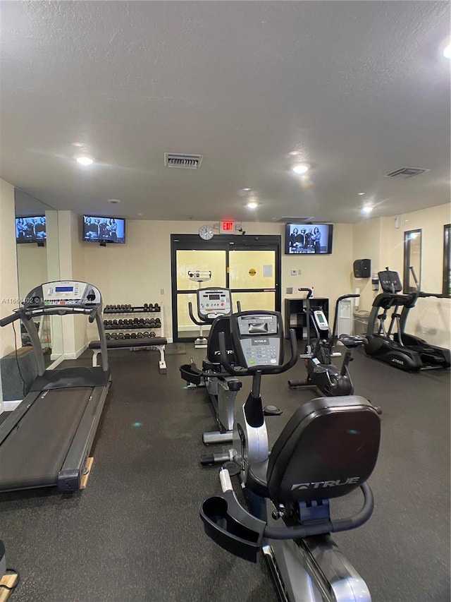 workout area with a textured ceiling