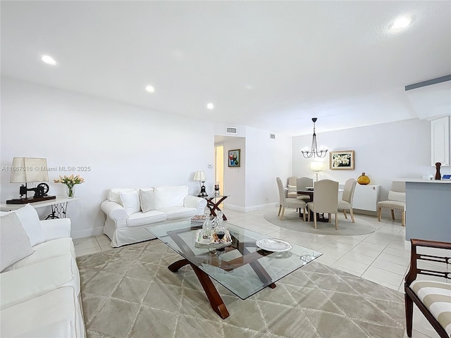 living room with light tile patterned flooring and an inviting chandelier