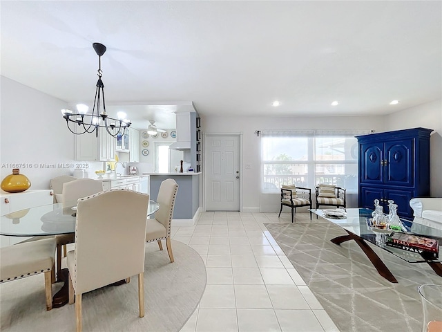 tiled dining area featuring sink and a chandelier