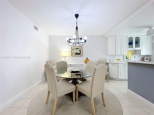 dining room featuring light tile patterned floors and ceiling fan with notable chandelier