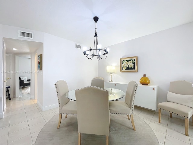 tiled dining space with an inviting chandelier