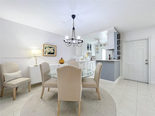 tiled dining room featuring ceiling fan with notable chandelier