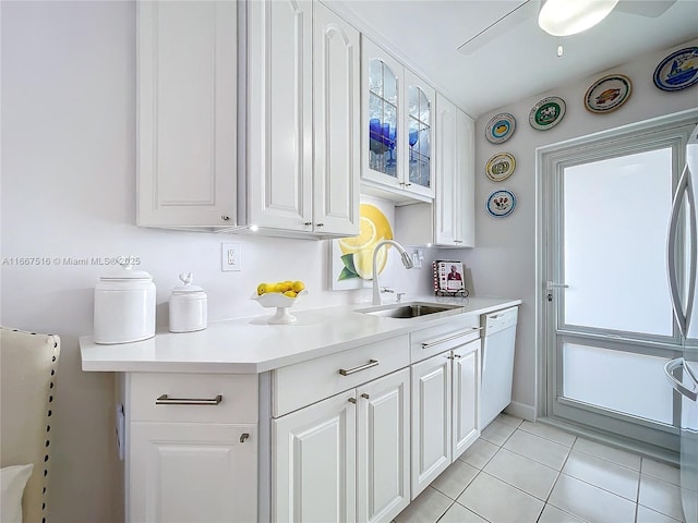 kitchen featuring white cabinetry, dishwasher, sink, and light tile patterned floors