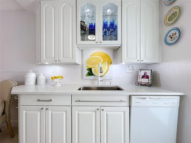 kitchen featuring dishwasher, white cabinets, and sink