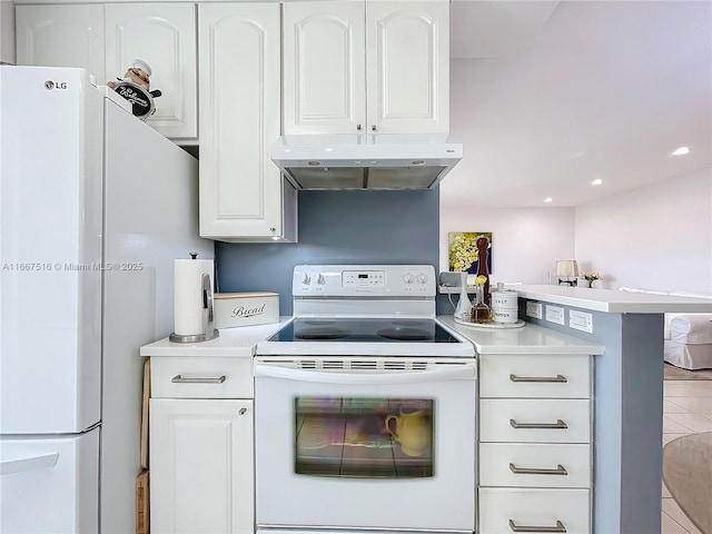 kitchen featuring tile patterned flooring, white appliances, kitchen peninsula, and white cabinetry