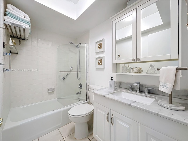 full bathroom featuring tile patterned floors, vanity, toilet, and tiled shower / bath