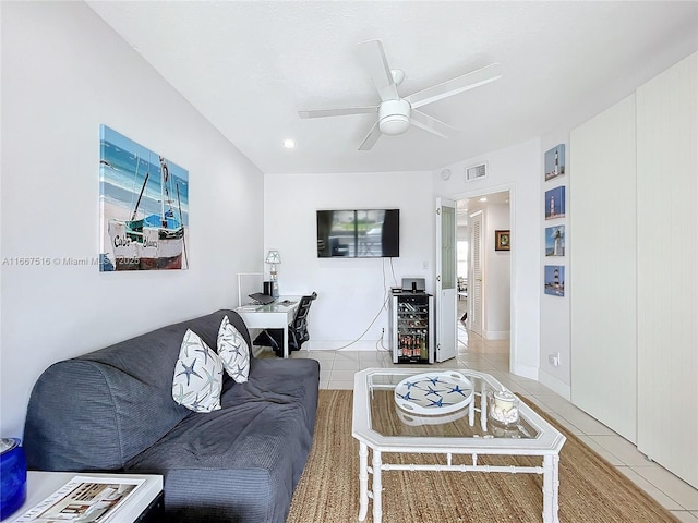 living room with ceiling fan, tile patterned flooring, and beverage cooler