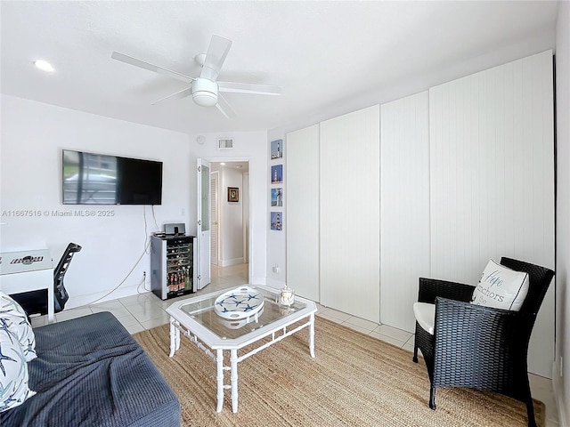 living room with ceiling fan and light tile patterned floors