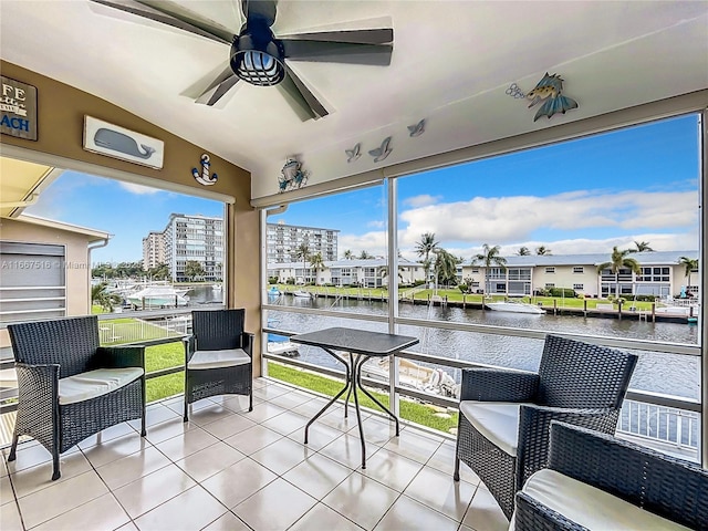 view of patio / terrace with a water view, ceiling fan, and a balcony