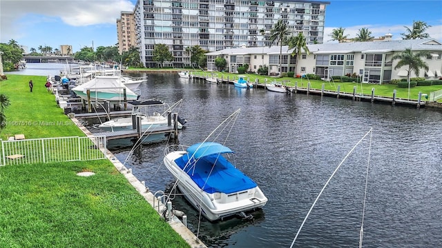 dock area with a yard and a water view